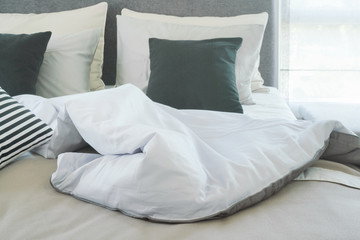Fototapeta na wymiar Messy blanket on bed in the morning