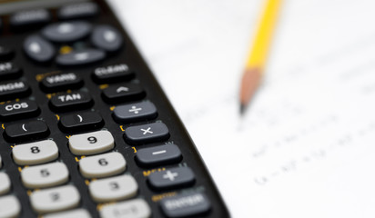calculator and pencil isolated on a white background
