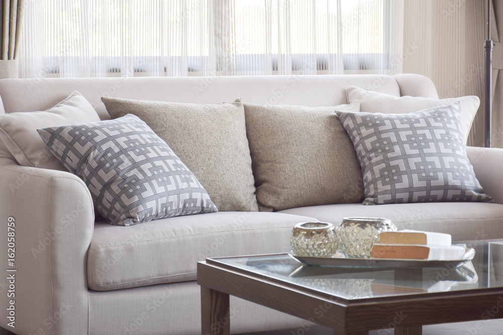 Wall mural pattern pillows setting on beige sofa in warm living room