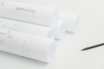 Close up scroll of architectural drawing and pencil on architect's working table