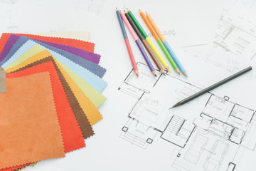 Architectural drawing with sample of material on working desk