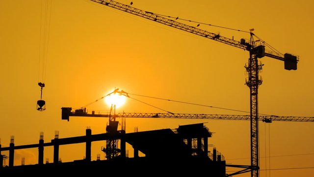Silhouette Crane Working In Construction Site 4K Time Lapse