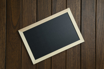empty blackboard on vintage wooden background
