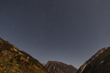 Obraz na płótnie Canvas Mountain with little snow on the top with stars in the night at Lachen in North Sikkim, India.