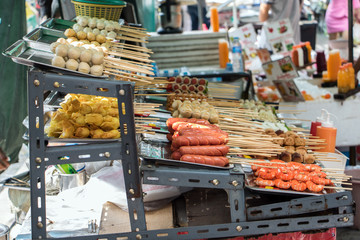 sausages on skewers in a street kiosk, Bangkok, Thailand. Thai cuisine on street in the city center.