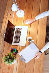 Portrait of relaxed young woman sitting at her desk holding cup of coffee. Business Woman. Workplace