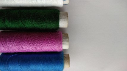 isolated multicolor sewing threads on white background 
