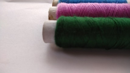 isolated multicolor sewing threads on white background 