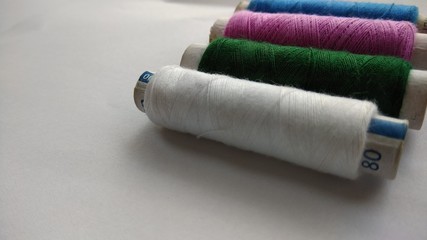 Fototapeta na wymiar isolated multicolor sewing threads on white background 