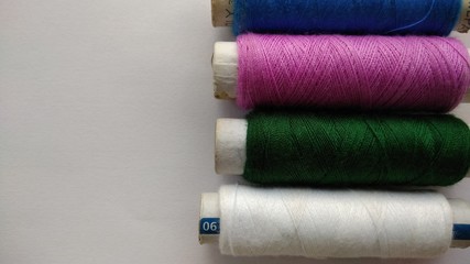 isolated multicolor sewing threads on white background 