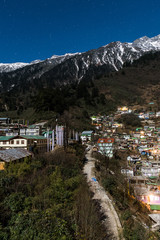 Fototapeta na wymiar Mountain with little snow on the top with village in the night at Lachen in North Sikkim, India