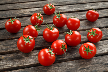 Fresh cherry ripe red tomatoes from home garden on rustic wooden table. selected focus