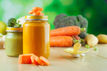 Jars with vegetable carrot and broccoli puree