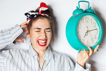 young woman driven crazy by alarm clock