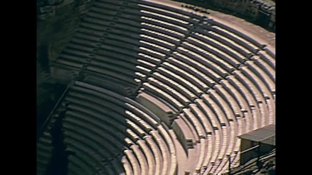 Odeon of Herodes Atticus aerial view from Acropolis hill with close up on theater ruins, southwest slope of the Acropolis of Athens in Greece. Restored historical 70s archival footage on 1972.
