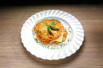 Potato pancake burger with ham and cheese