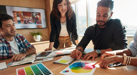 Group of creative designers discuss the color palette