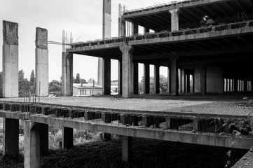 Abandoned construction site building. Abandoned place. Building skeleton. Black and white.