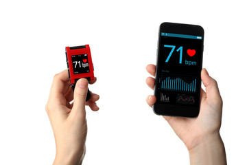 Female hands with heart rate monitor watch and smart phone on white background