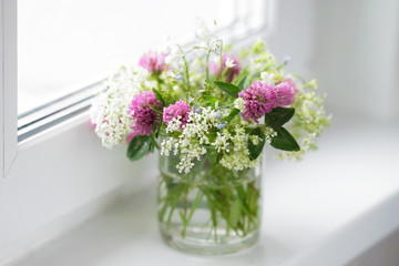 A bouquet of wild flowers on the window, soft focus.