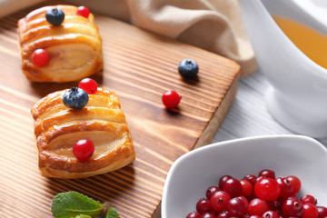 Wooden cutting board with pastries, closeup