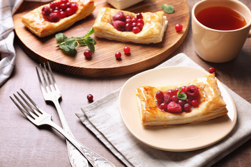 Delicious pastries with berries on served table
