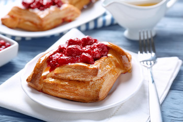 Delicious pastries with berries on served table