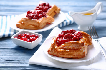 Delicious pastries with cherry and cranberry on served table