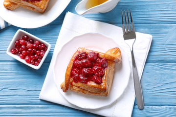 Delicious pastries with cherry and cranberry on served table