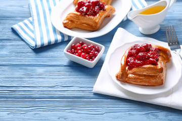 Delicious pastries with cherry and cranberry on served table