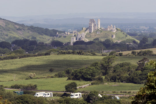 Campsite with a backdrop of Corfe Castle in the Dorset countryside, Southern England UK. June 2017