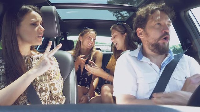 Teenage daughters laughing while parents are fighting in car unha