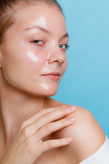 Woman in facial peel off mask.