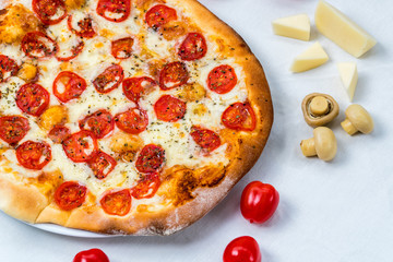 Pizza margarita. Cheese and tomato on background. White cloth