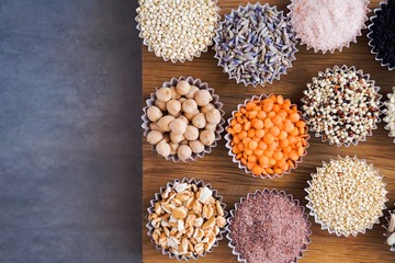 Various superfoods, seeds, cereals, grains on a gray background. Healthy eating concept. Top view