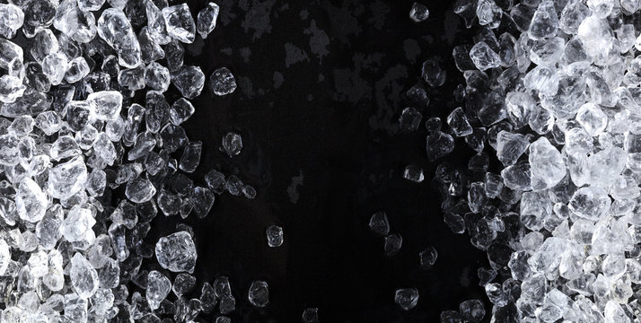 Pieces Of Crushed Ice Cubes On Black Background. Copy Space, Top View