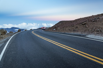 Mountain road above the clouds after sunset 