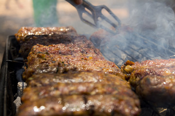 Barbecue beef kebabs cooking on hot grill