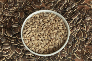 Dried unshelled sunflower seeds on a wooden table. Vegetarian food