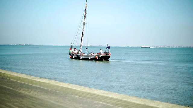 View of boat floating on the sea, steadycam shot
