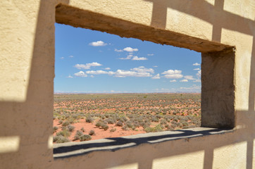 blue sky and vast desert view through the window 
Navajo Nation Reservation, AZ-98 route, Arizona, United States