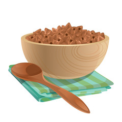 Wooden bowl with buckwheat in it / Wooden bowl stands on the green napkin. There is a buckwheat in the bowl and near the bowl lay brown wooden spoon
