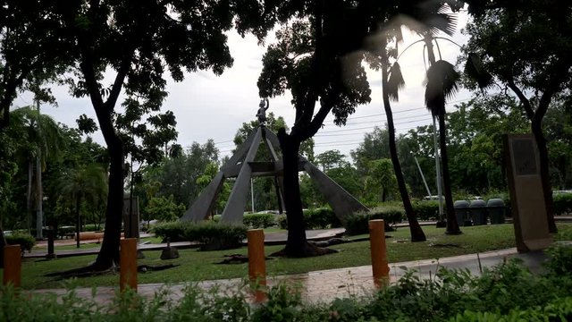 The park with statue and trees. City park. The monument to the cat