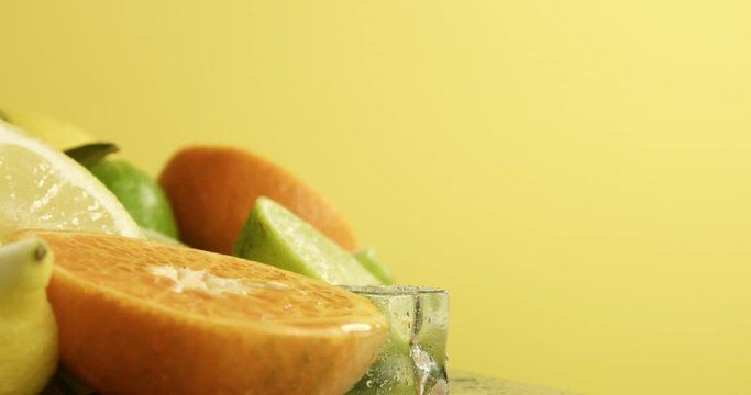 composition of limen, orange and lime with an ice cubes turning on