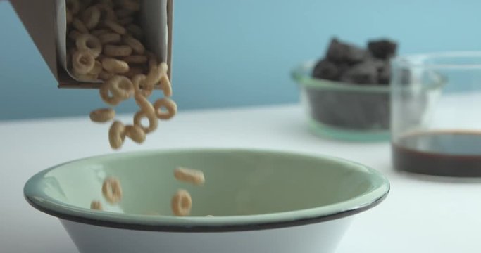 corn flakes rings falling on a bowl slow motion. Breakfast theme footage