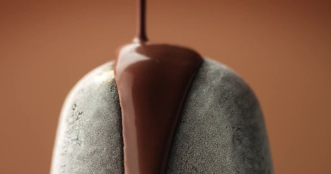 chocolate ice cream on a stick and liquid chocolate covered it. Different chocolate textures