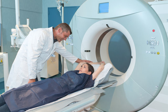 male doctor reassuring female patient before computed tomography scan
