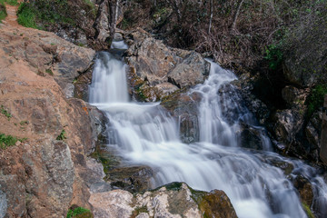 Fototapeta premium Waterfall at the Hidden Falls Regional Park, Auburn, California, USA, in the end of the Winter of 2017, after many rainstorms- long exposure