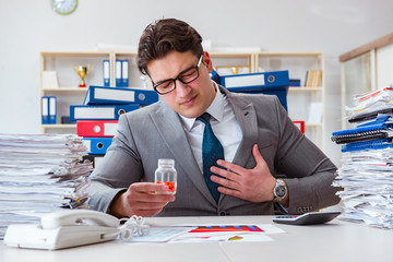 Businessman taking pills to cope with stress