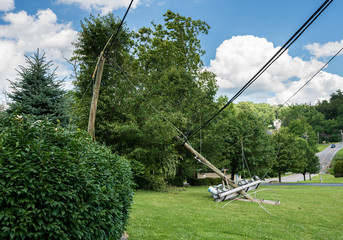 Snapped and downed power post and line after storm